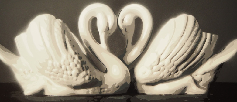 Two ceramic swans facing each other