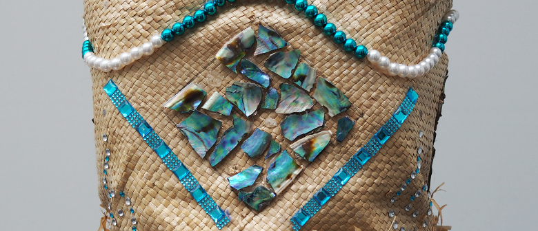 A flax kete decorated with paua shell