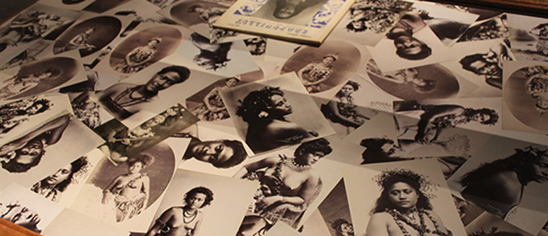 Black and white photos of Pacifika women are strewn through a display case