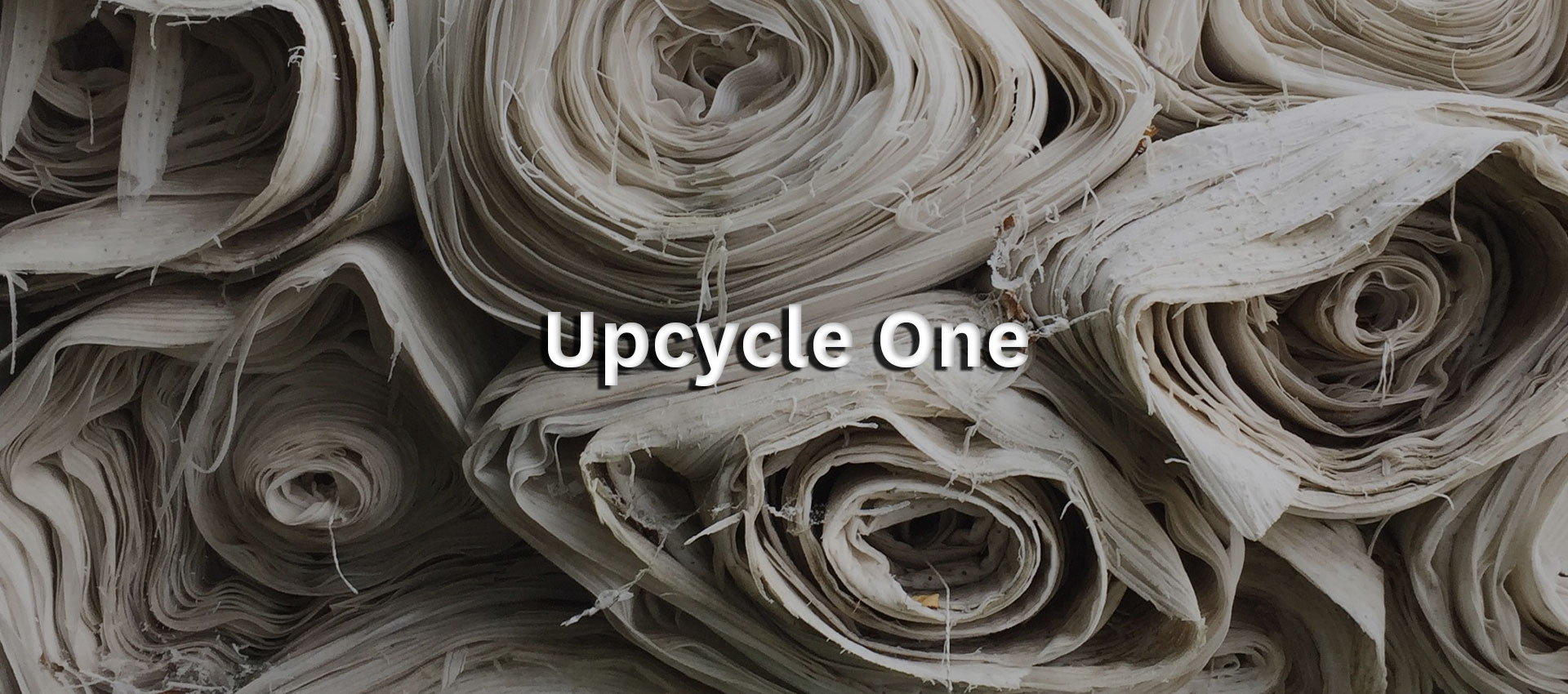 Event title: Upcycle One with piles of old fabric