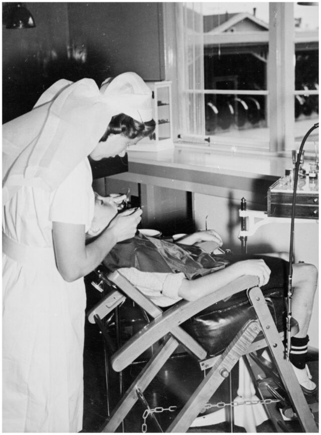 A dental nurse and child in a dental clinic