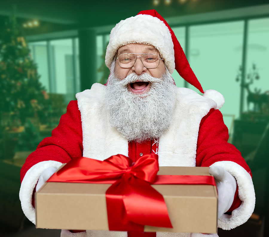 Photo of Santa Claus holding a wrapped present
