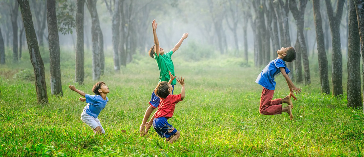Children jumping in a field