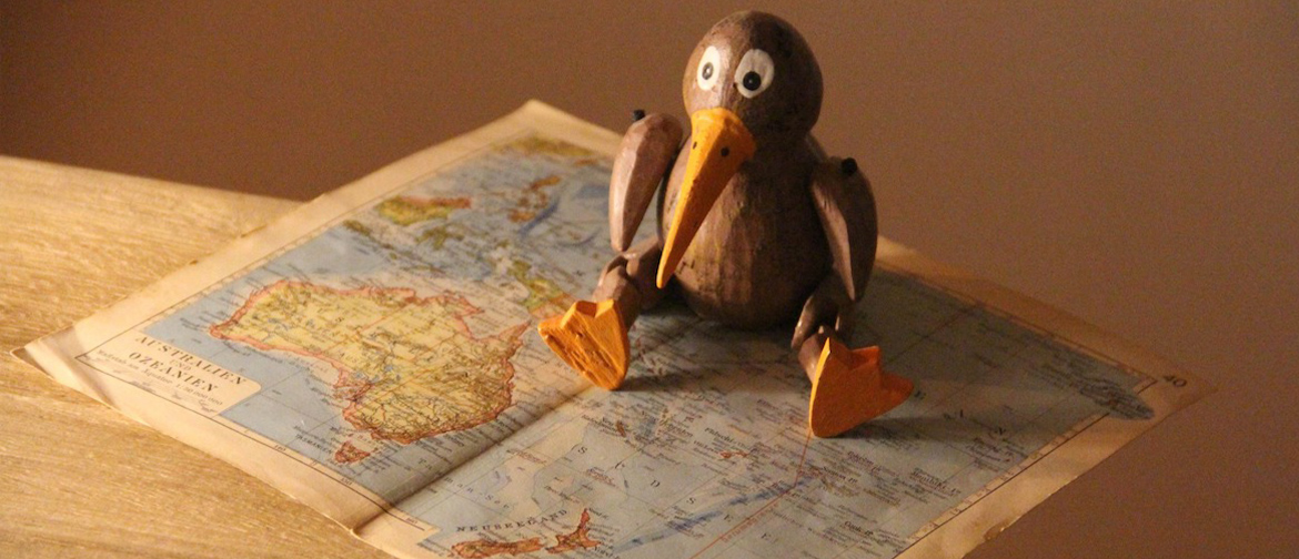 A kiwi sits on a map