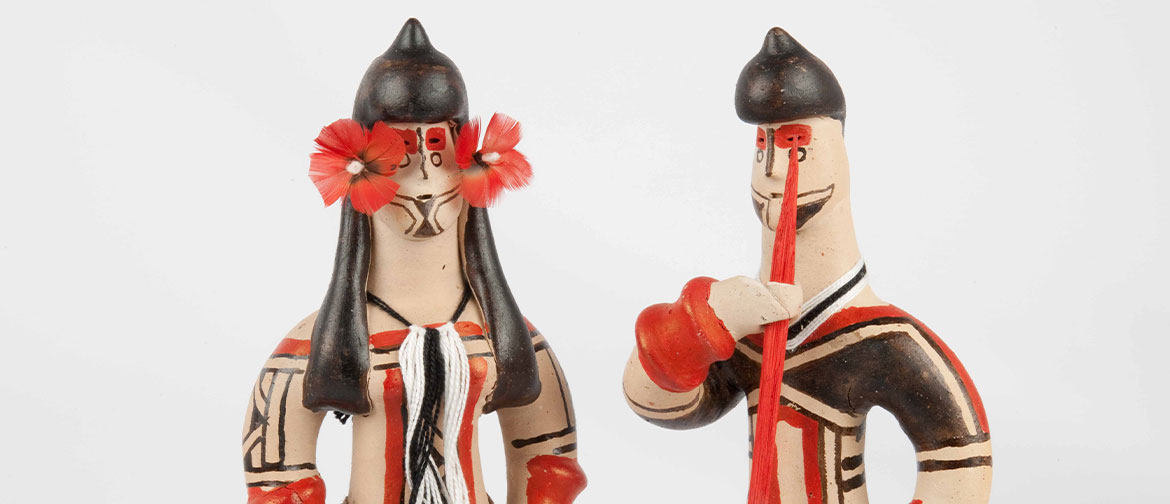 Two ceramic figures painted in red and black