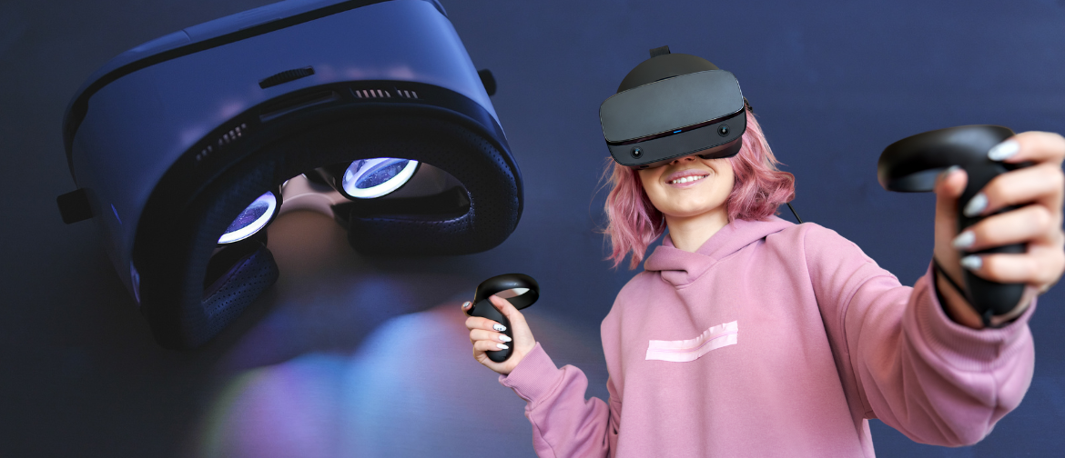 a girl with pink hair in a pink hoodie wears a virtual reality visor.