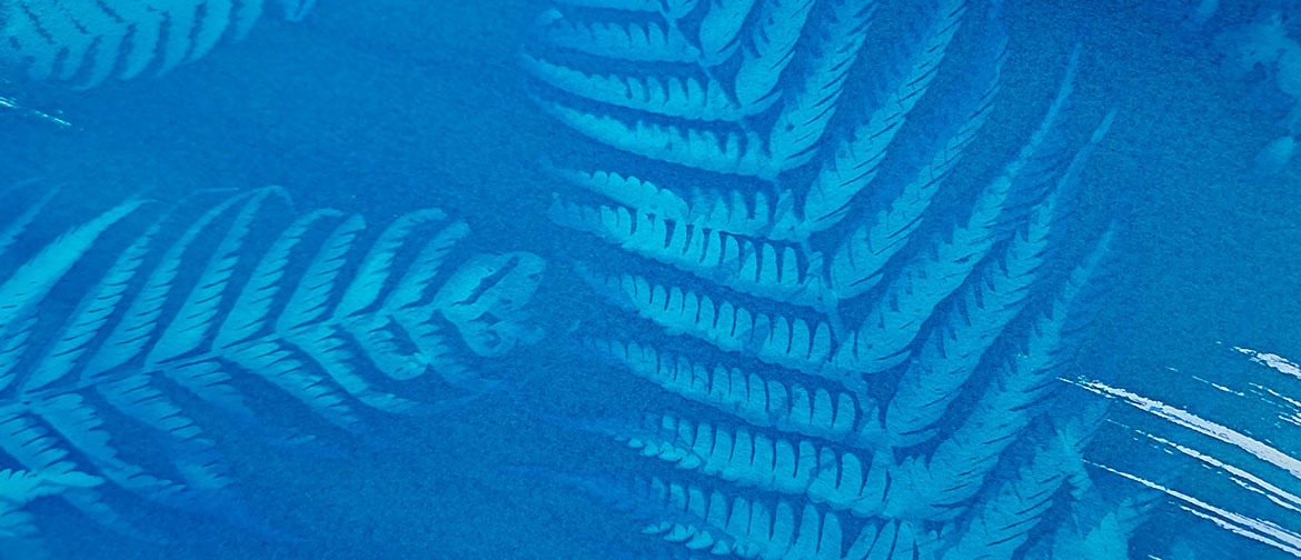 A fern print in blue ink