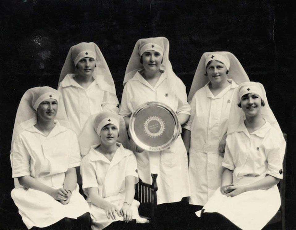 A black and white photo of six women in nurse uniform