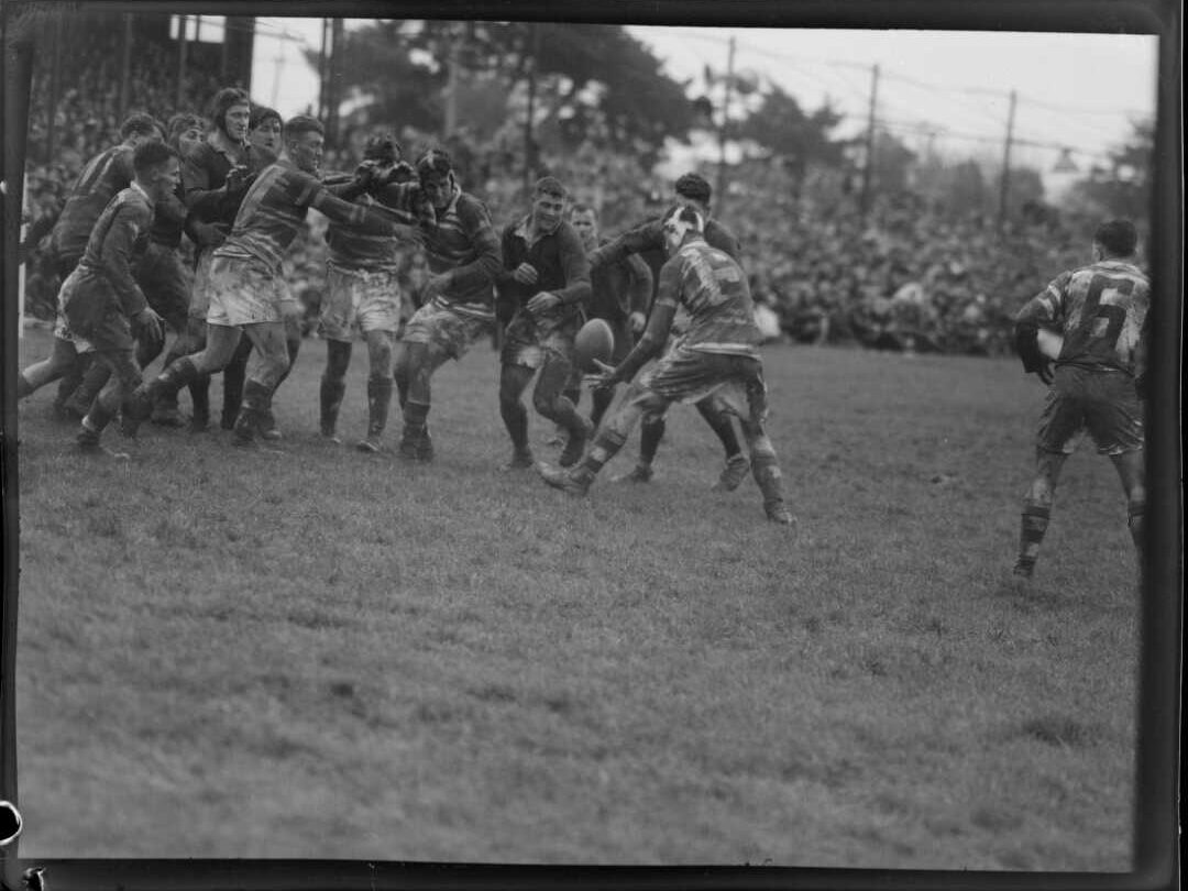 A black and white photo of a rugby game