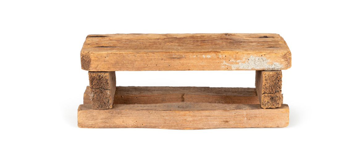 Photograph of a wooden seat made by a boy and his father on a plain white background