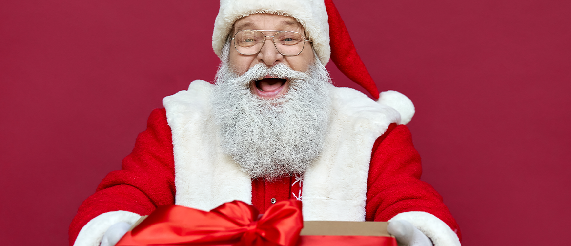 Photograph of Santa Claus offering a wrapped giftbox