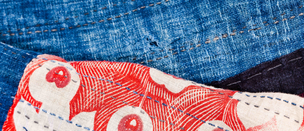 Close up of Boro garment with red and blue boro stitching